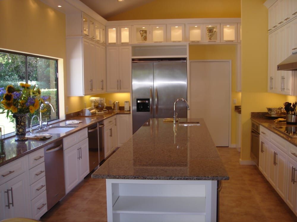 A kitchen with stainless steel appliances and granite counter tops