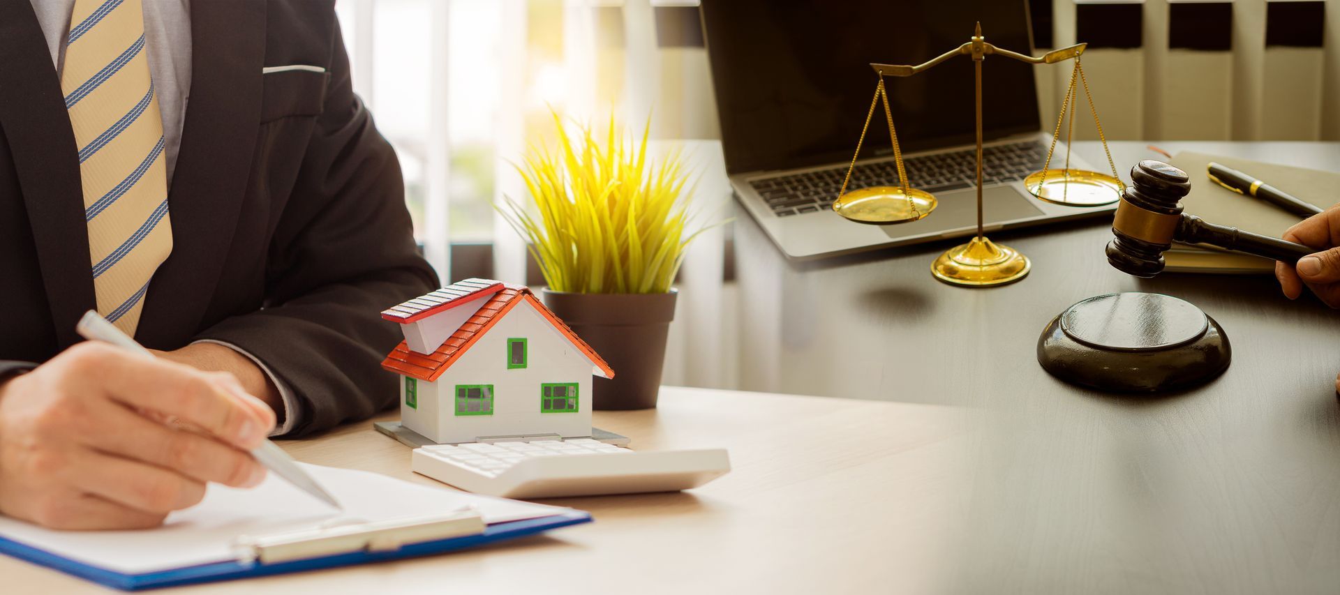 Real estate agent with attorney holding a hammer on finance approval.