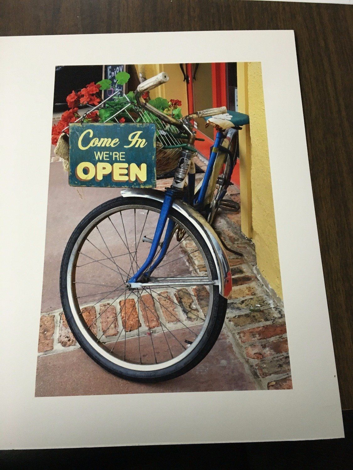 A picture of a bicycle with a sign that says come in we 're open