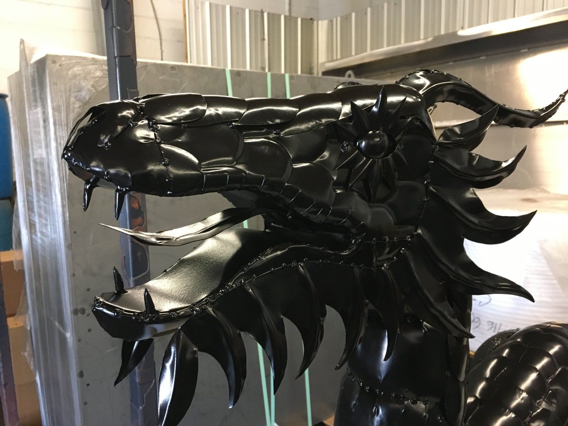 A close up of a black dragon statue in a room