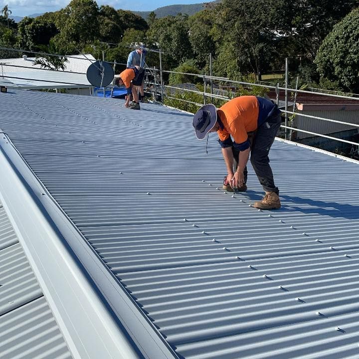 Roof plumbers inspecting a roof in Townsville