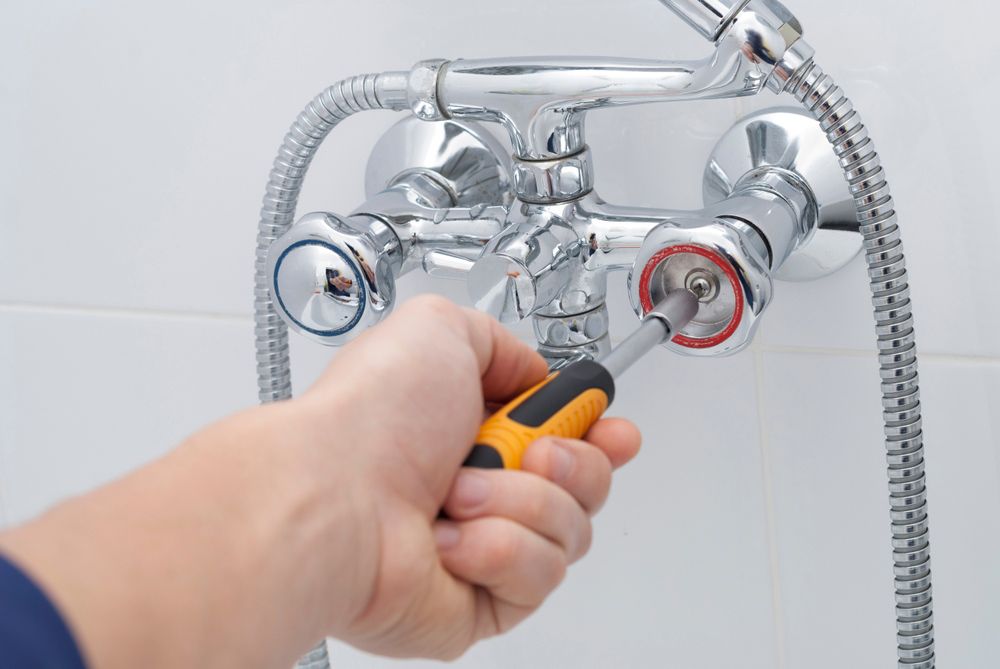Plumber repairs the faucet in the bathroom — Showers in Jensen QLD