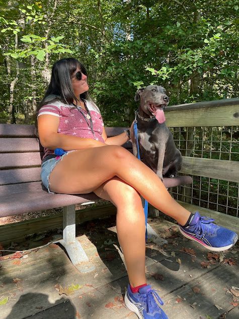 Trainer working with a dog on a trail hike in Wendell, NC, practicing the Place command in an outdoor setting. Dog training in Wendell helps dogs build focus, stability, and obedience while navigating natural environments with distractions like wildlife and terrain.