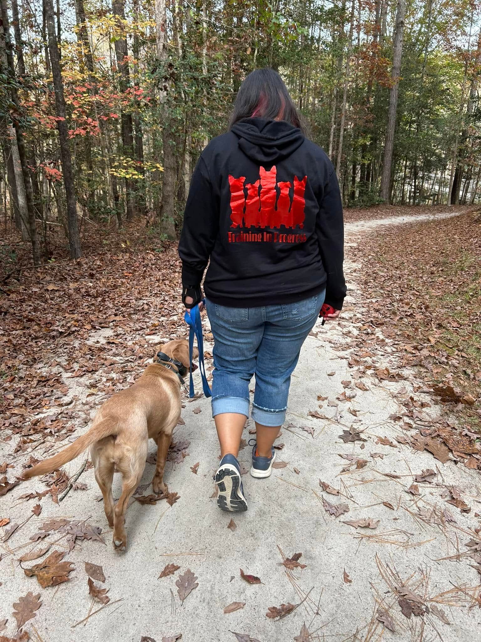 Dog working on Heel command during a trail hike at Turnipseed Nature Preserve, practicing obedience in a new outdoor location. Dog training at Turnipseed Nature Preserve focuses on improving Heel and other commands in diverse, real-world environments.