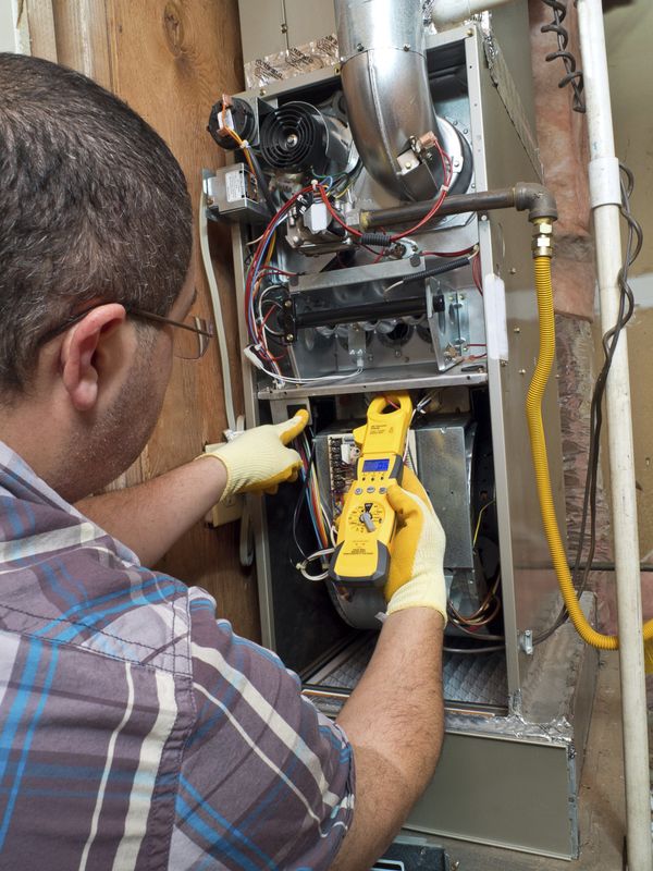 Furnace Repair — Repairman Conducting Furnace Repair in Spotsylvania, VA