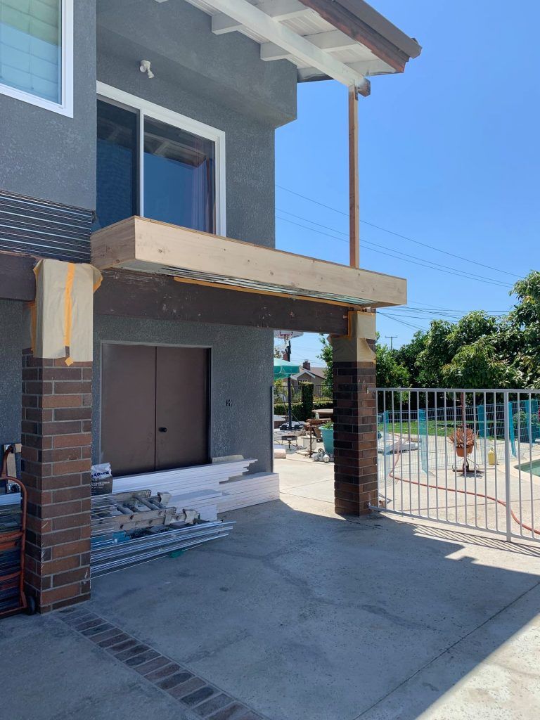 A house is being remodeled with a porch being built