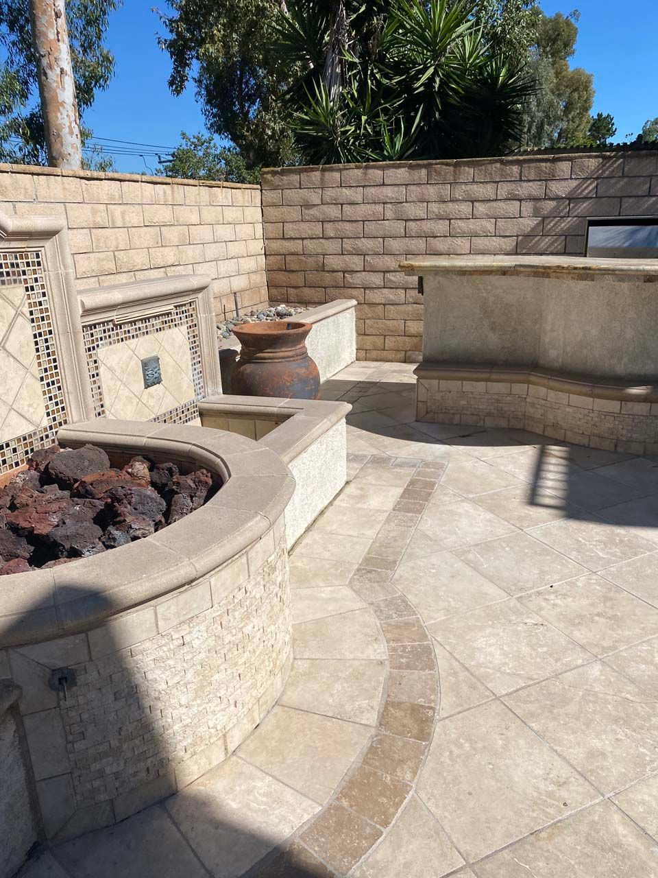 There is a fire pit in the middle of the patio.