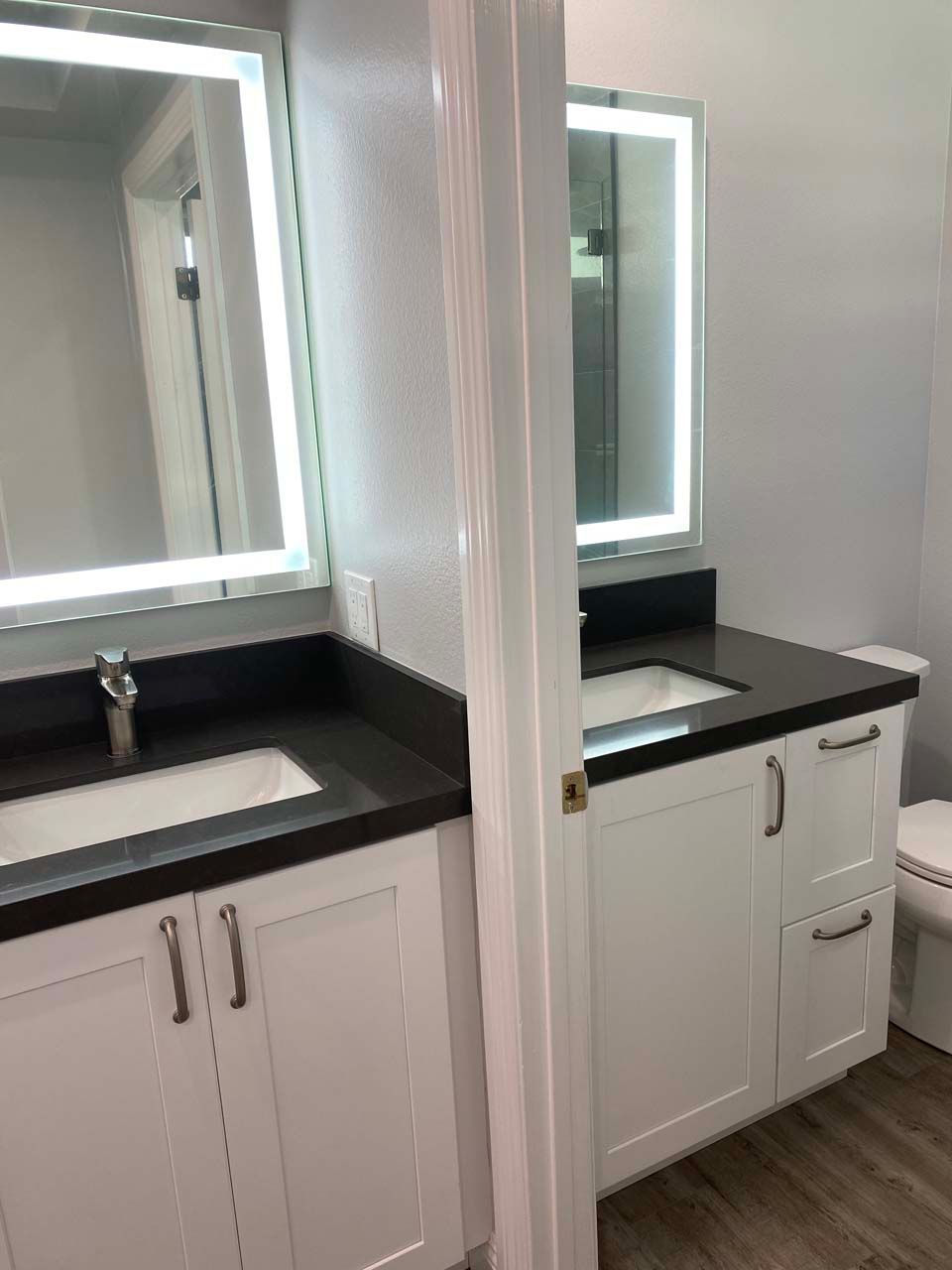 A bathroom with a sink , toilet and mirror.