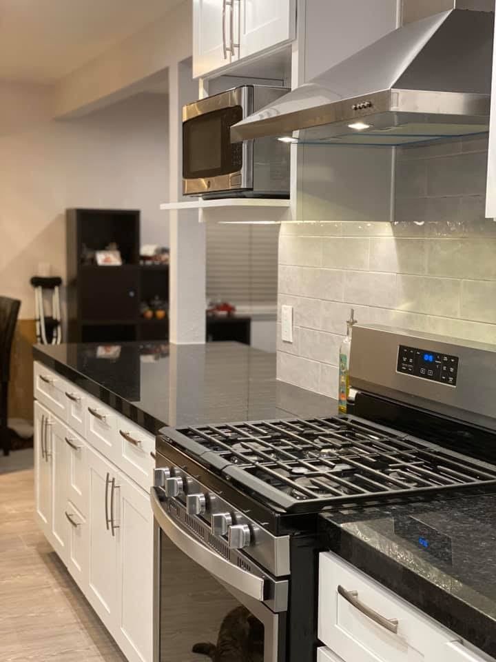 A kitchen with a stove top oven and a microwave.
