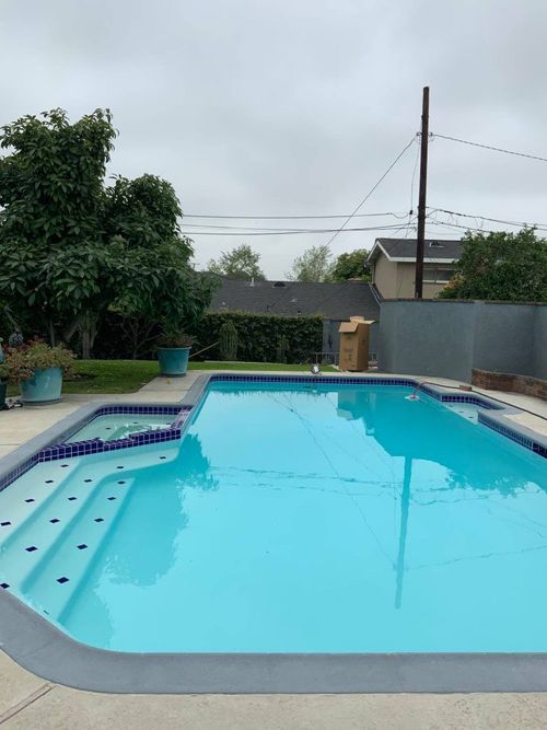 A large swimming pool in the backyard of a house