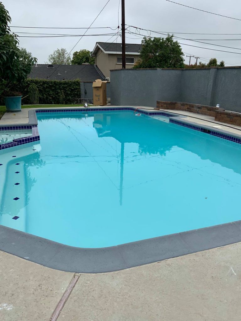 A large swimming pool with a fence around it