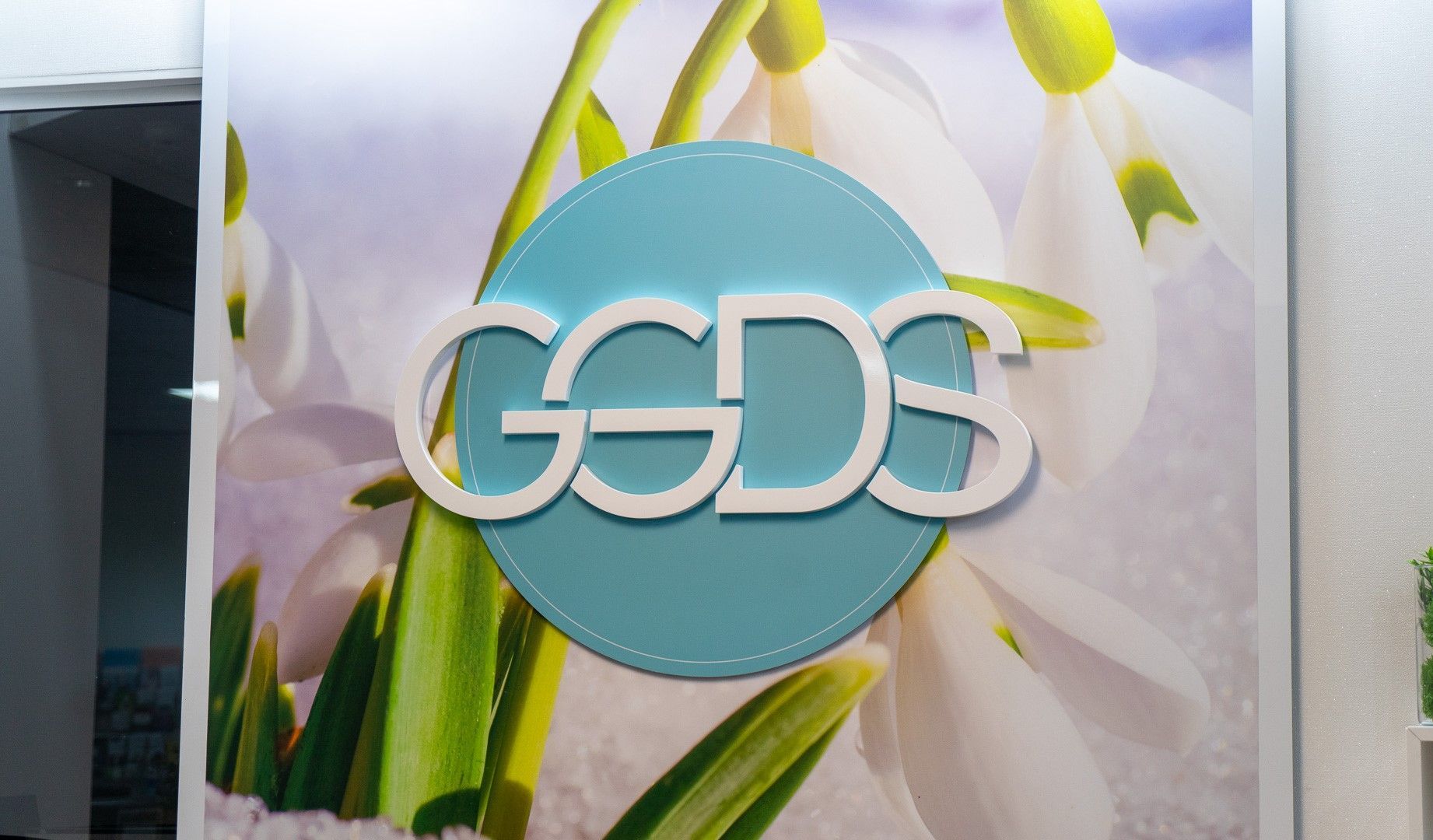 A woman with braces on her teeth is getting her teeth examined by a dentist.