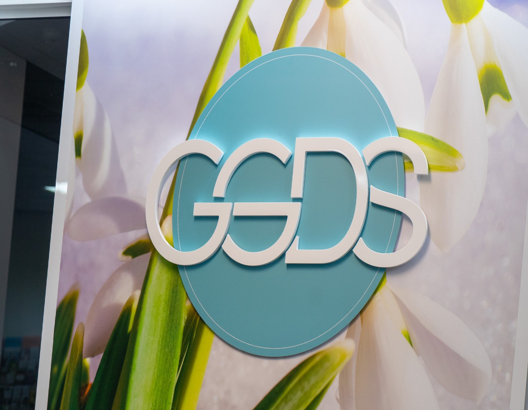 A teal oval sign featuring white