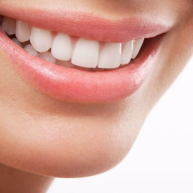 A person is holding a pair of clear braces in their hands.