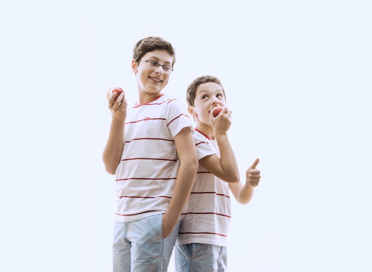 A woman is smiling for the camera while sitting at a table.
