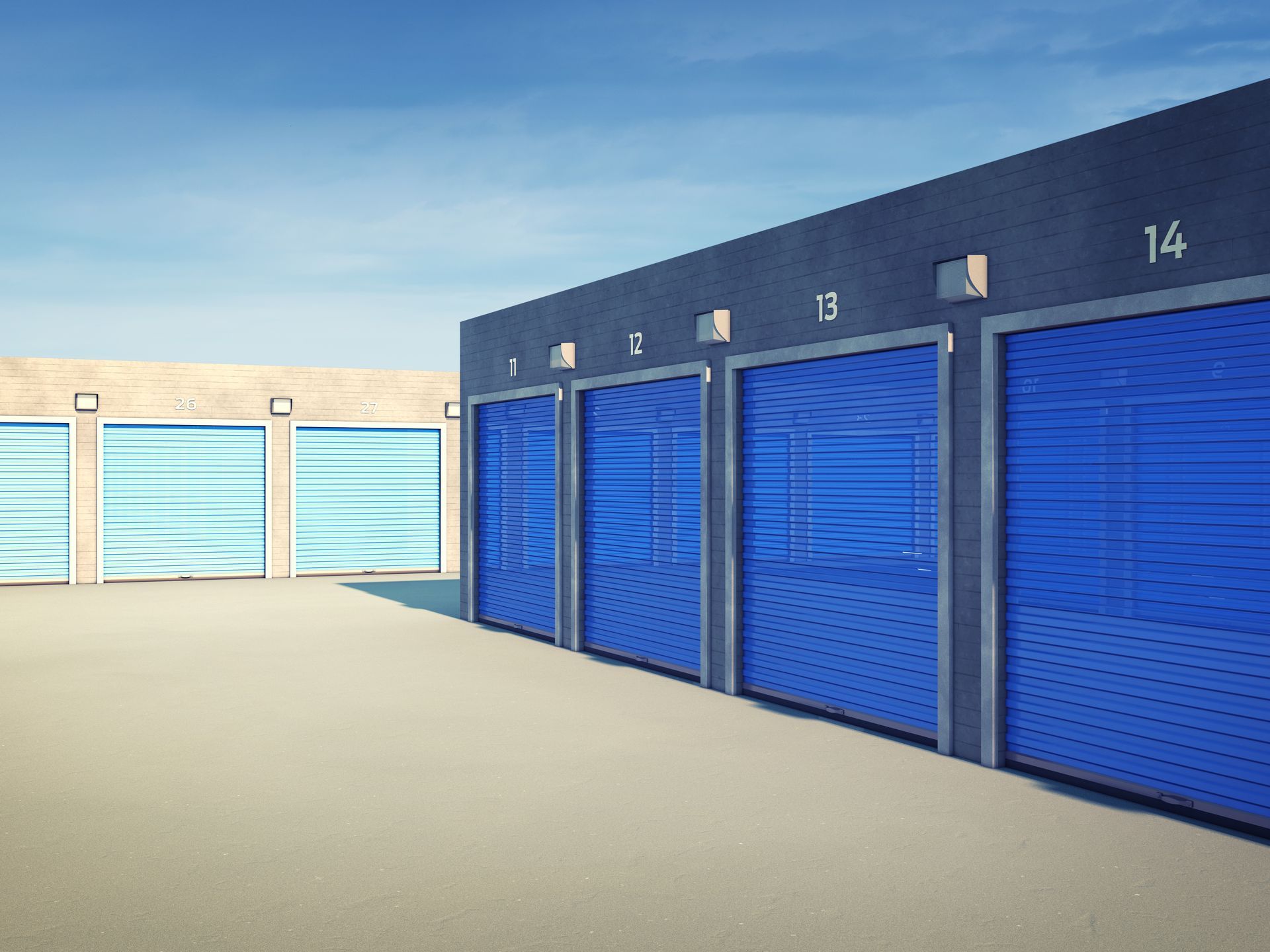 Storage unit hallway with red doors and a cart loaded with boxes.