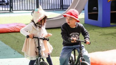 Two Kids Riding Bike — Auckland, NZ — Just Kidz