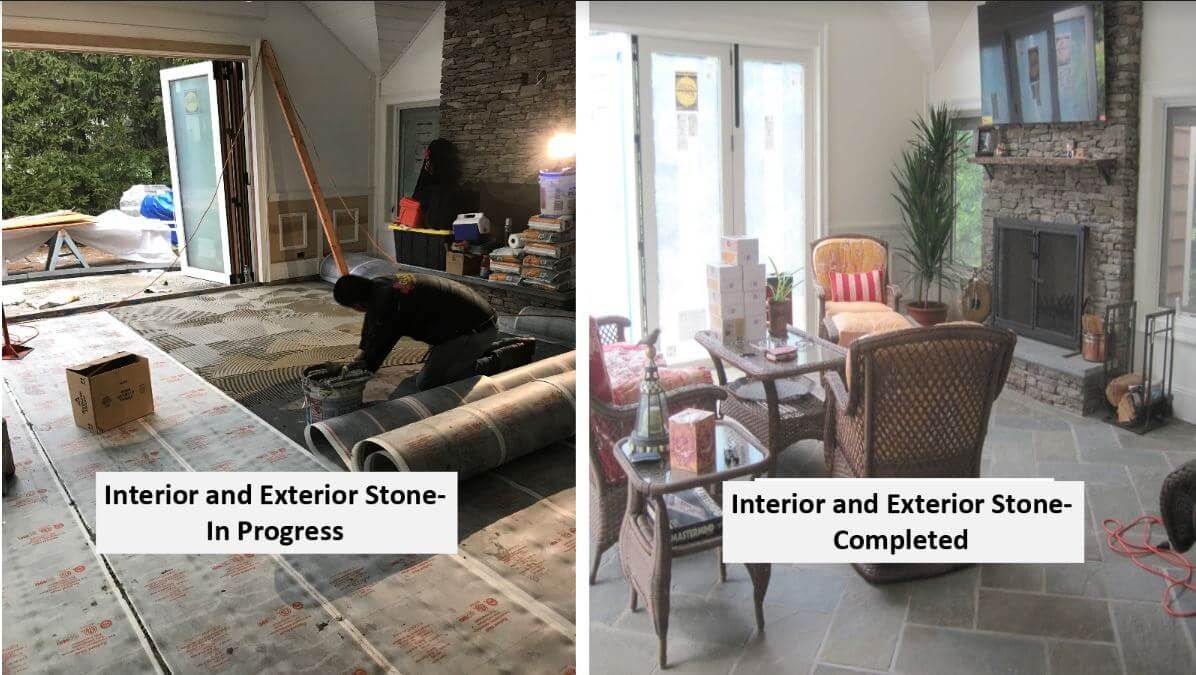 A man is laying a rug in a living room next to a fireplace.