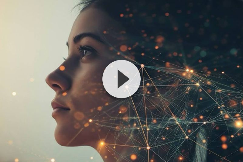 A double exposure of a woman 's face with a play button.