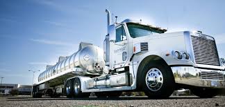 A large semi truck is parked on the side of the road.