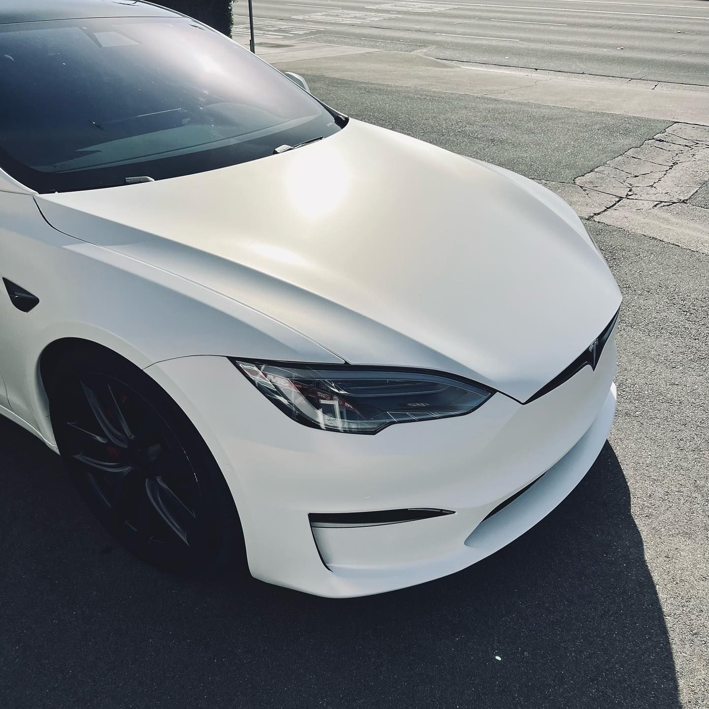 A close up of a yellow car 's side mirror