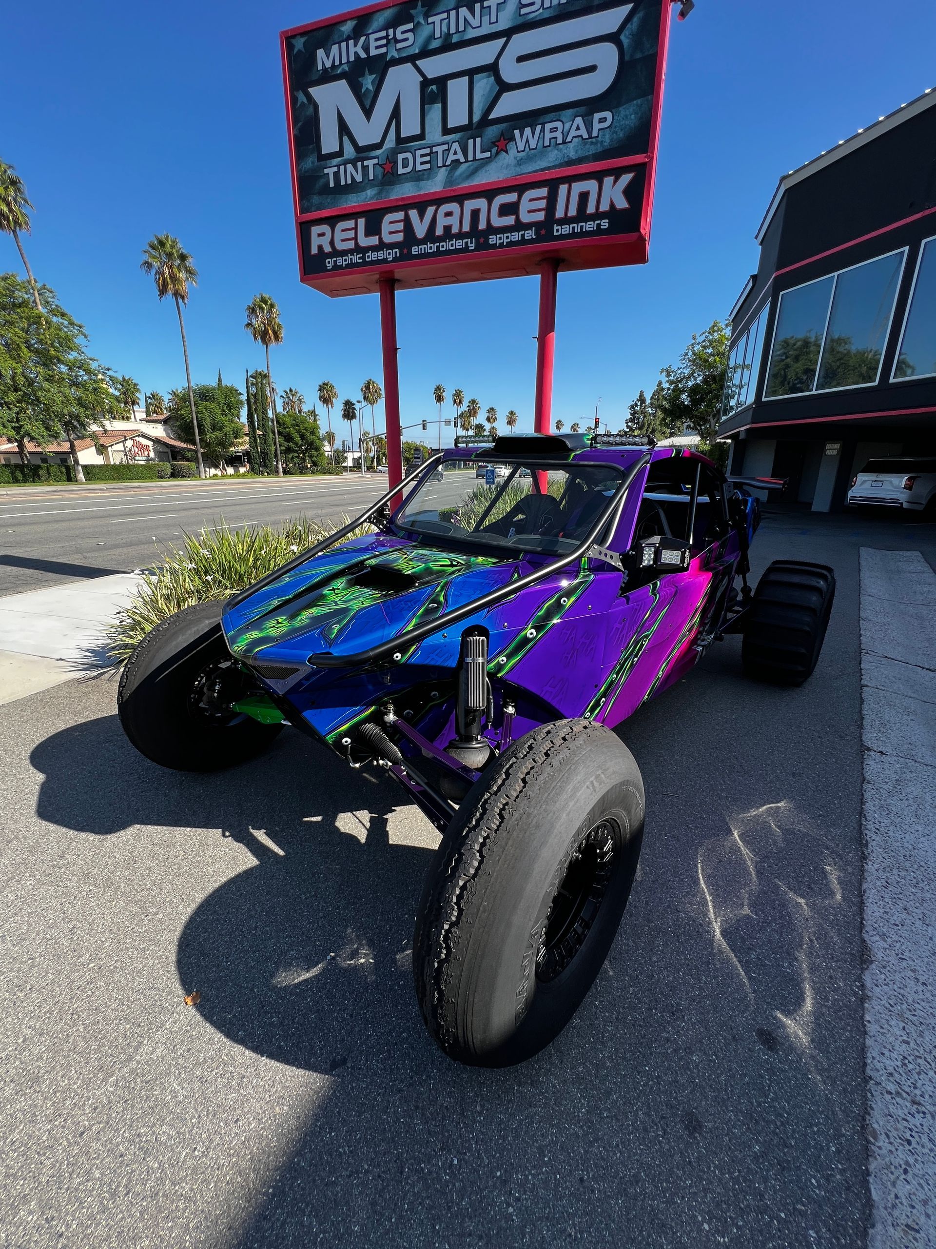 A close up of a yellow car 's side mirror