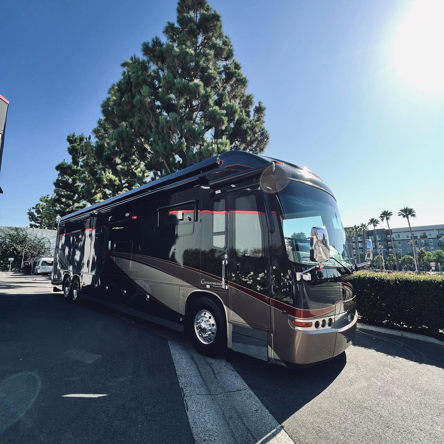 A large bus is parked on the side of the road