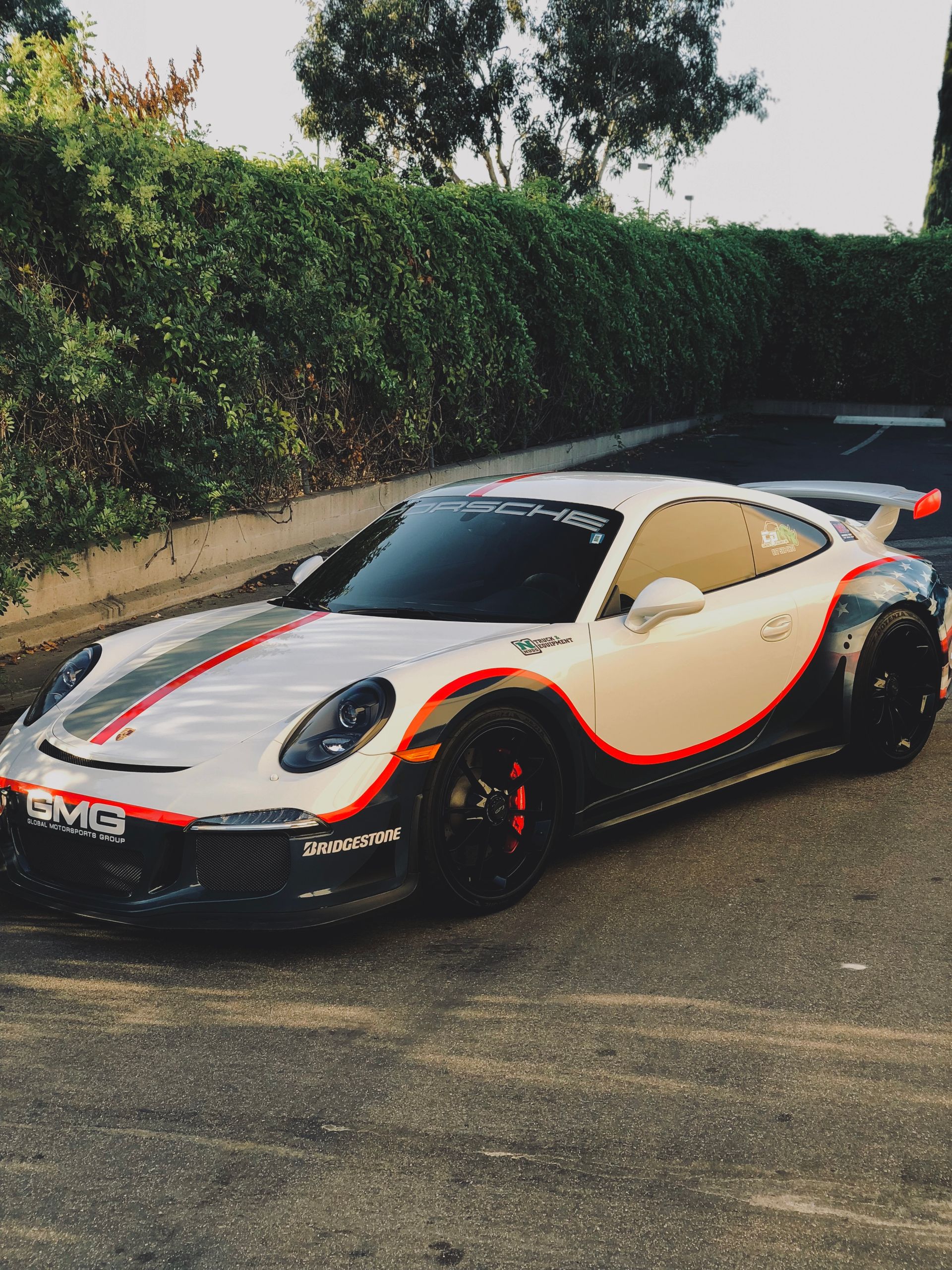 A white and red sports car is parked in a parking lot