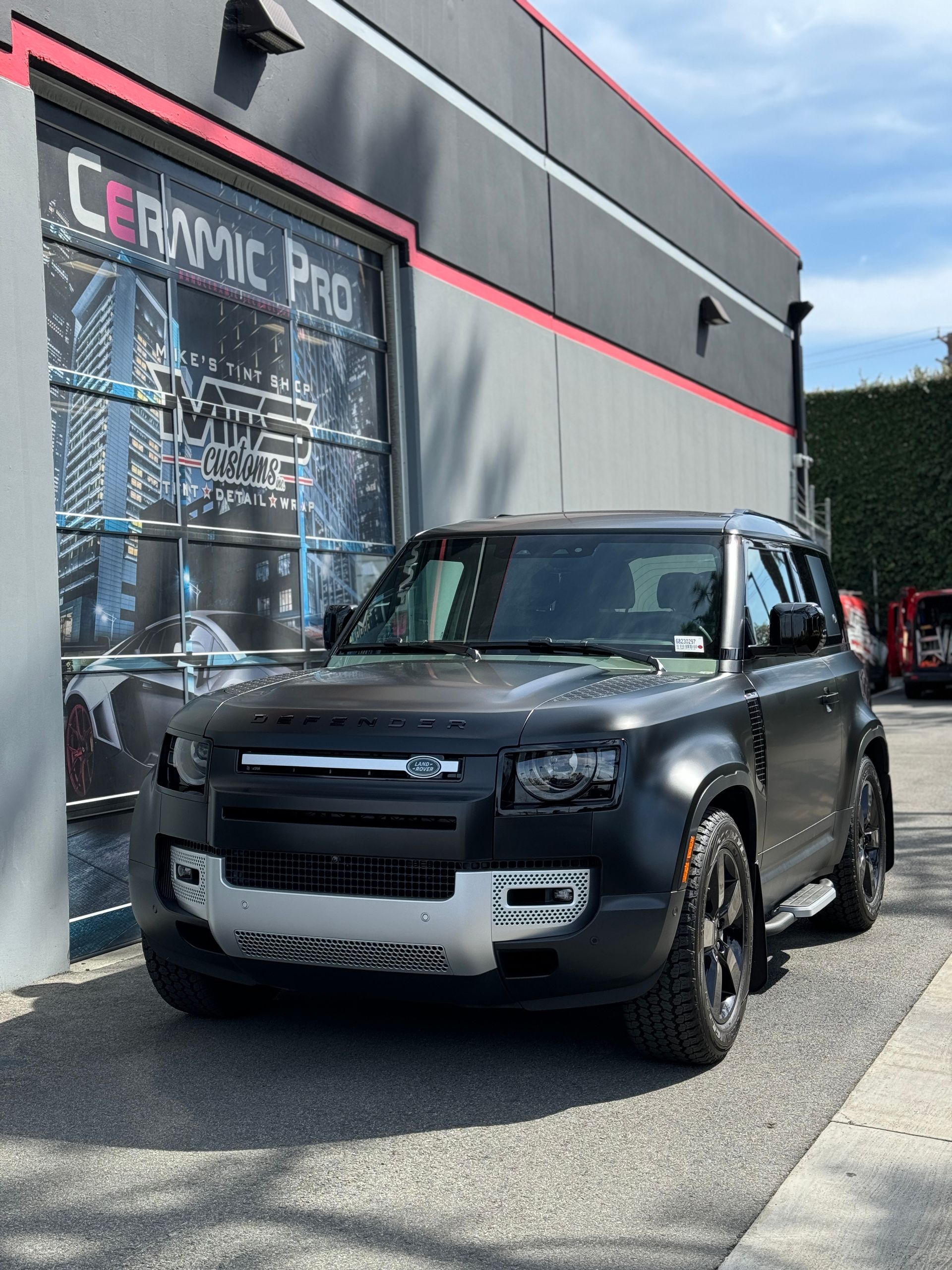 A tesla model x is parked in front of a building with a sign that says mts