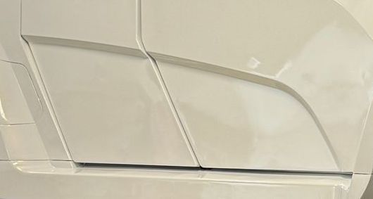 White car side panel with angled geometric design.