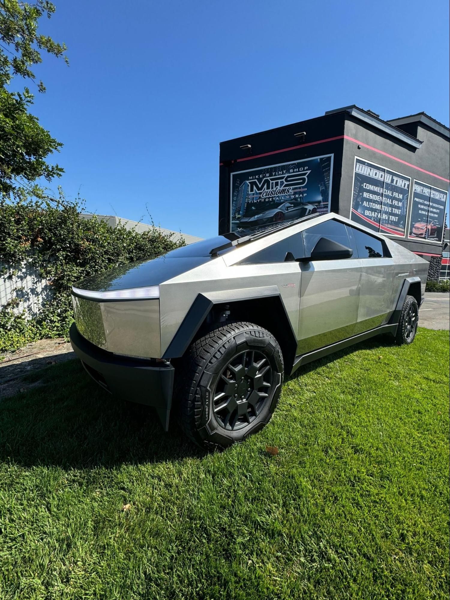Person using a tool to work on a car window.