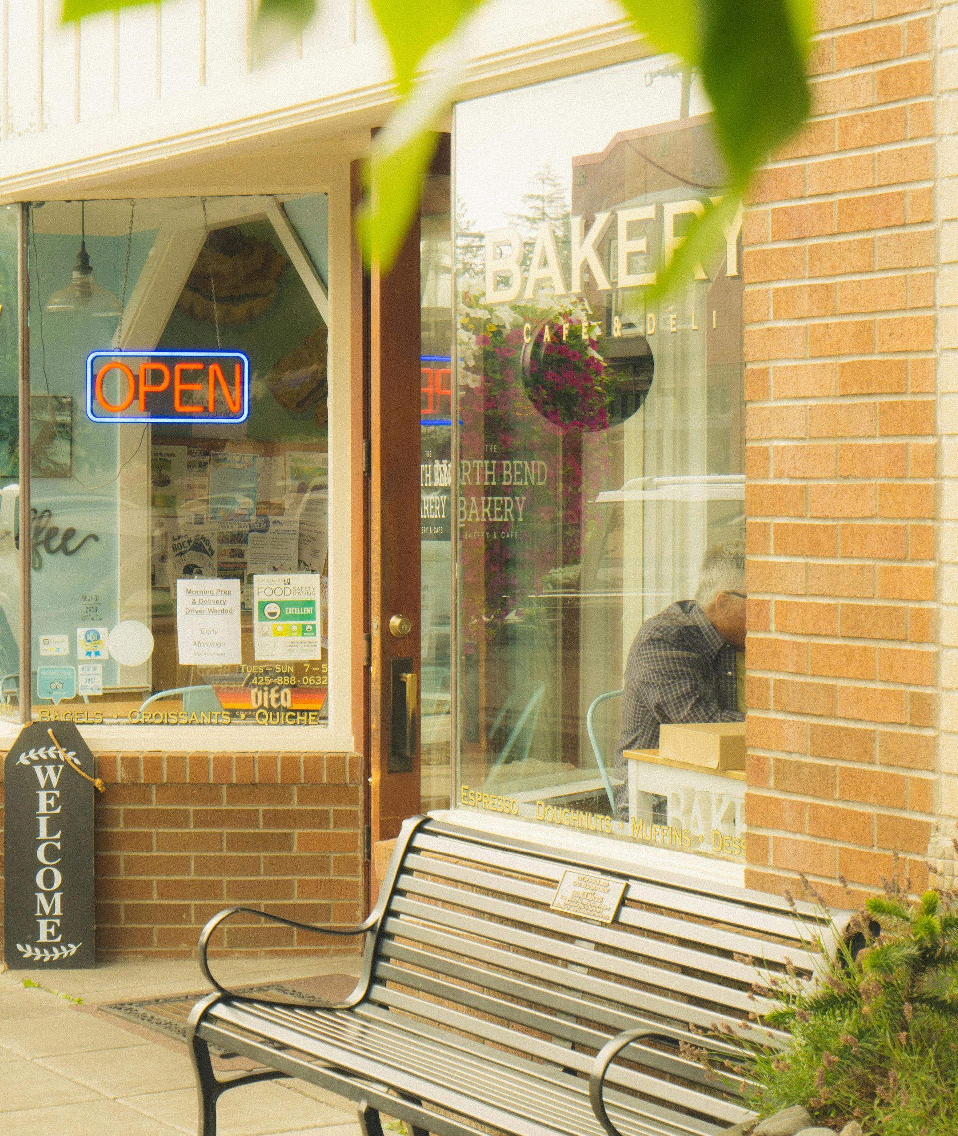 A bakery with a bench in front of it