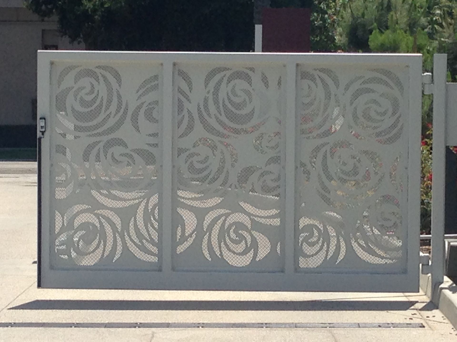 A white gate with a swirl design on it