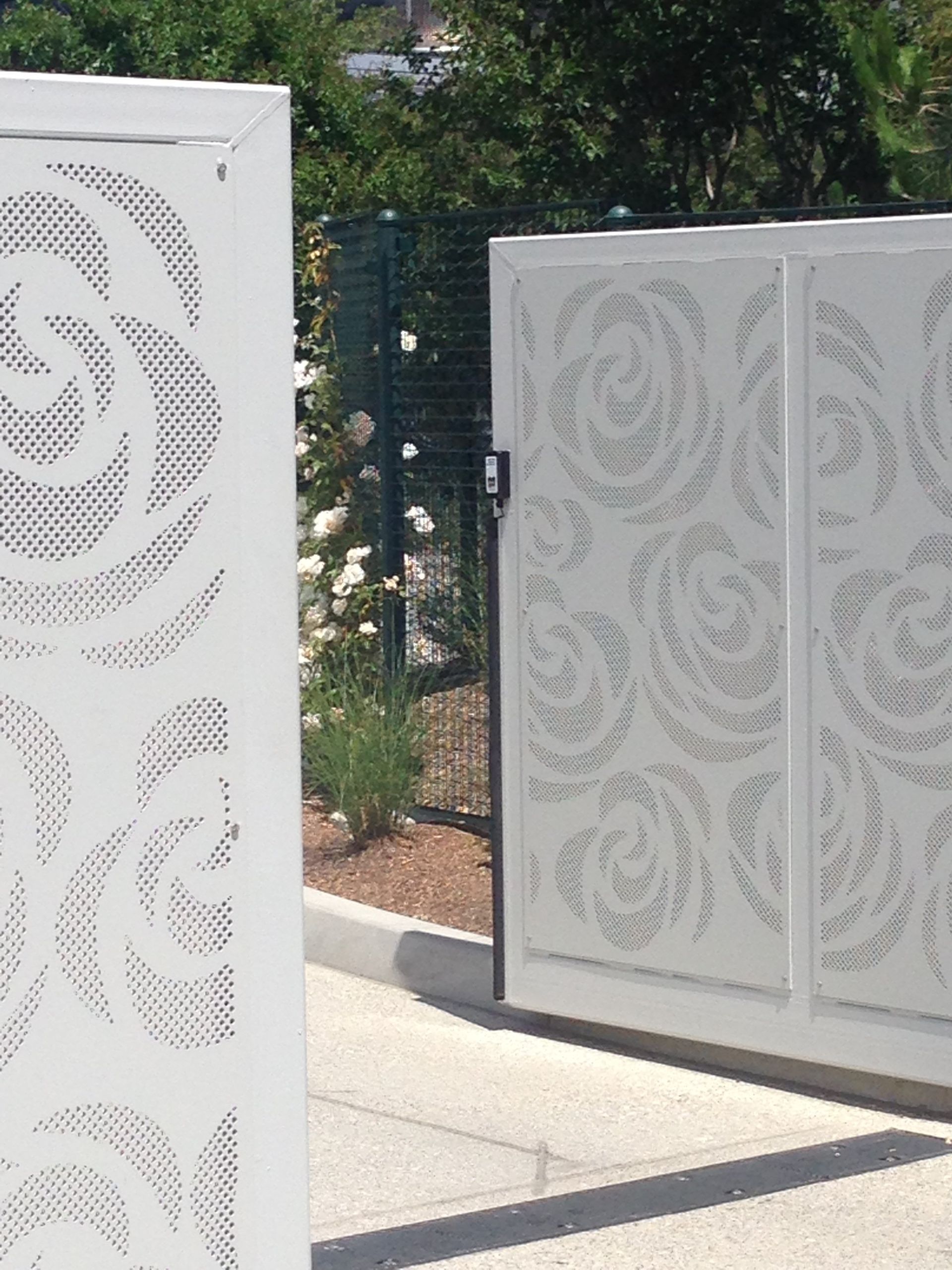 A white gate with a swirl pattern on it