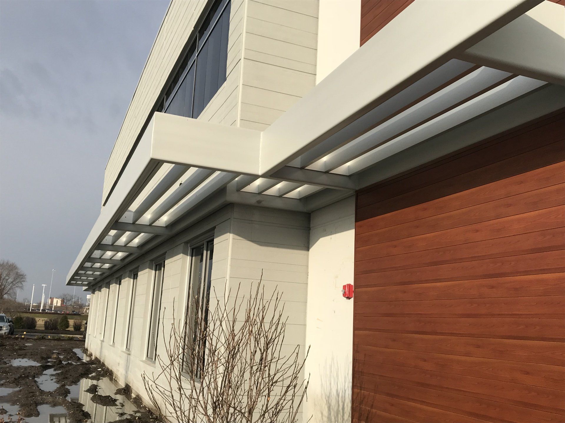 A building with a red fire alarm on the side