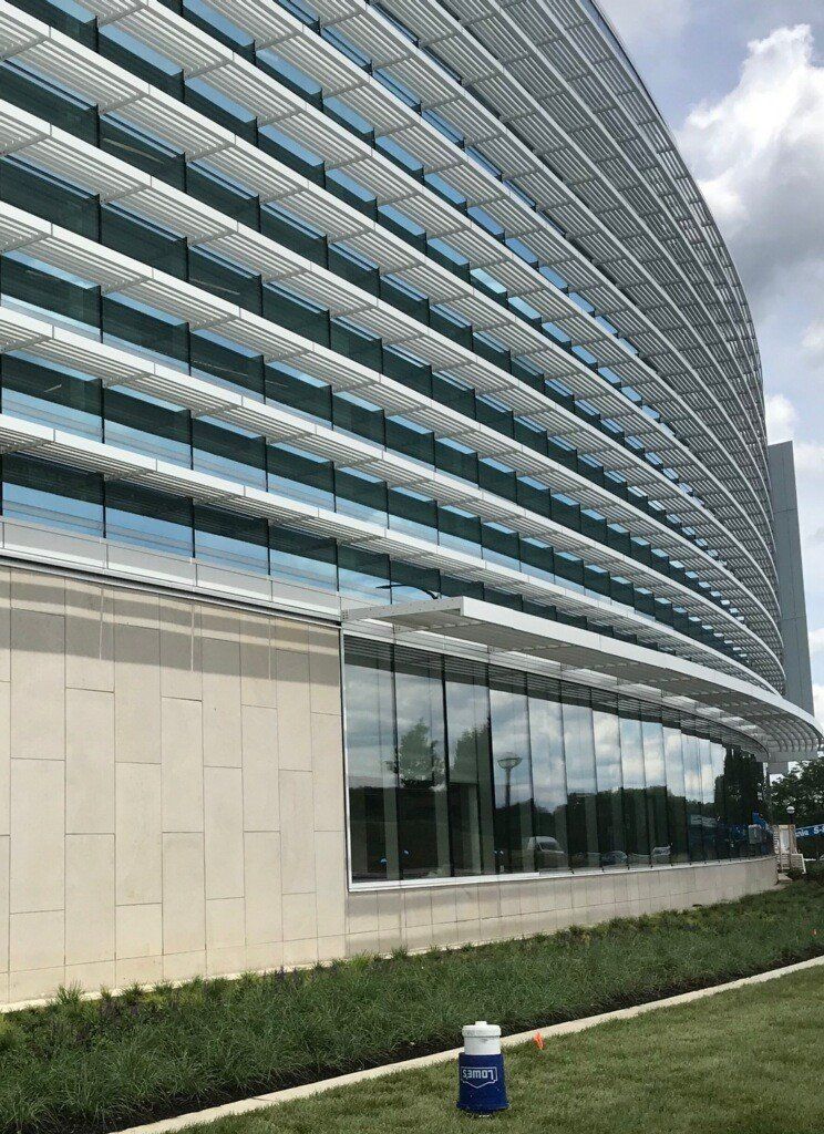 A large building with a lot of windows and a fire hydrant in front of it.