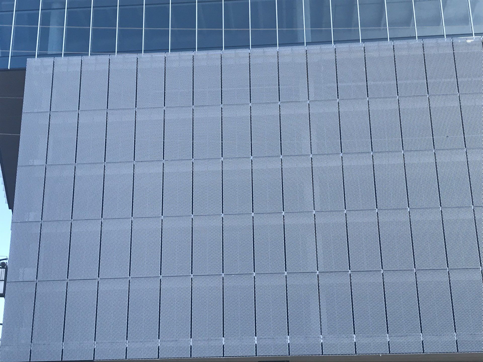 A large building with a lot of windows and a gray facade.