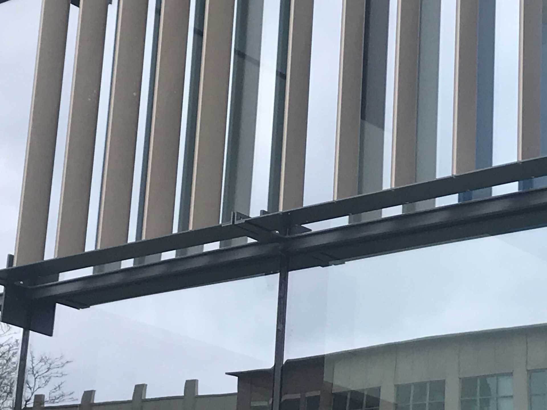 A close up of a fence with a building in the background