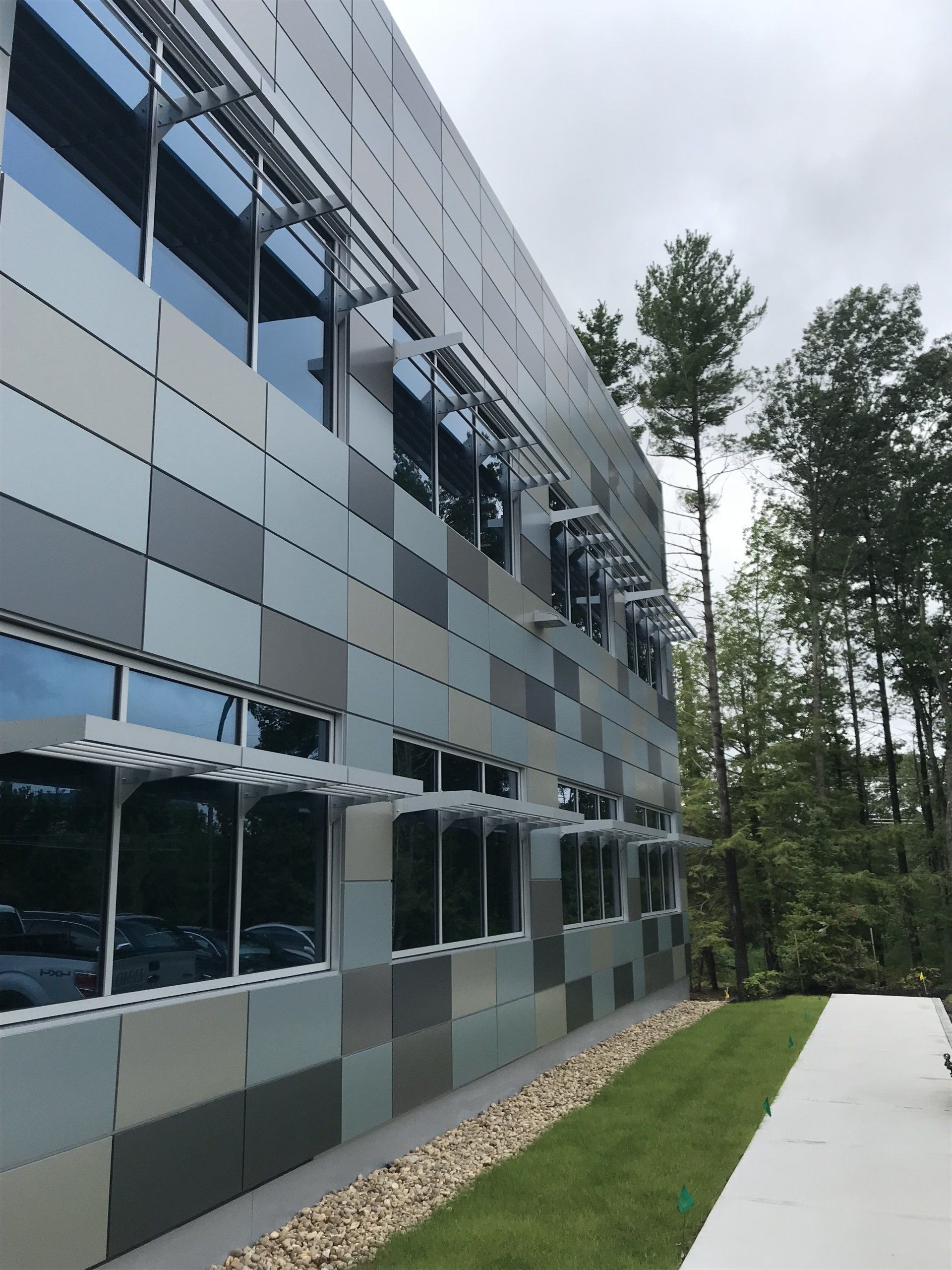 A building with a lot of windows and trees in the background