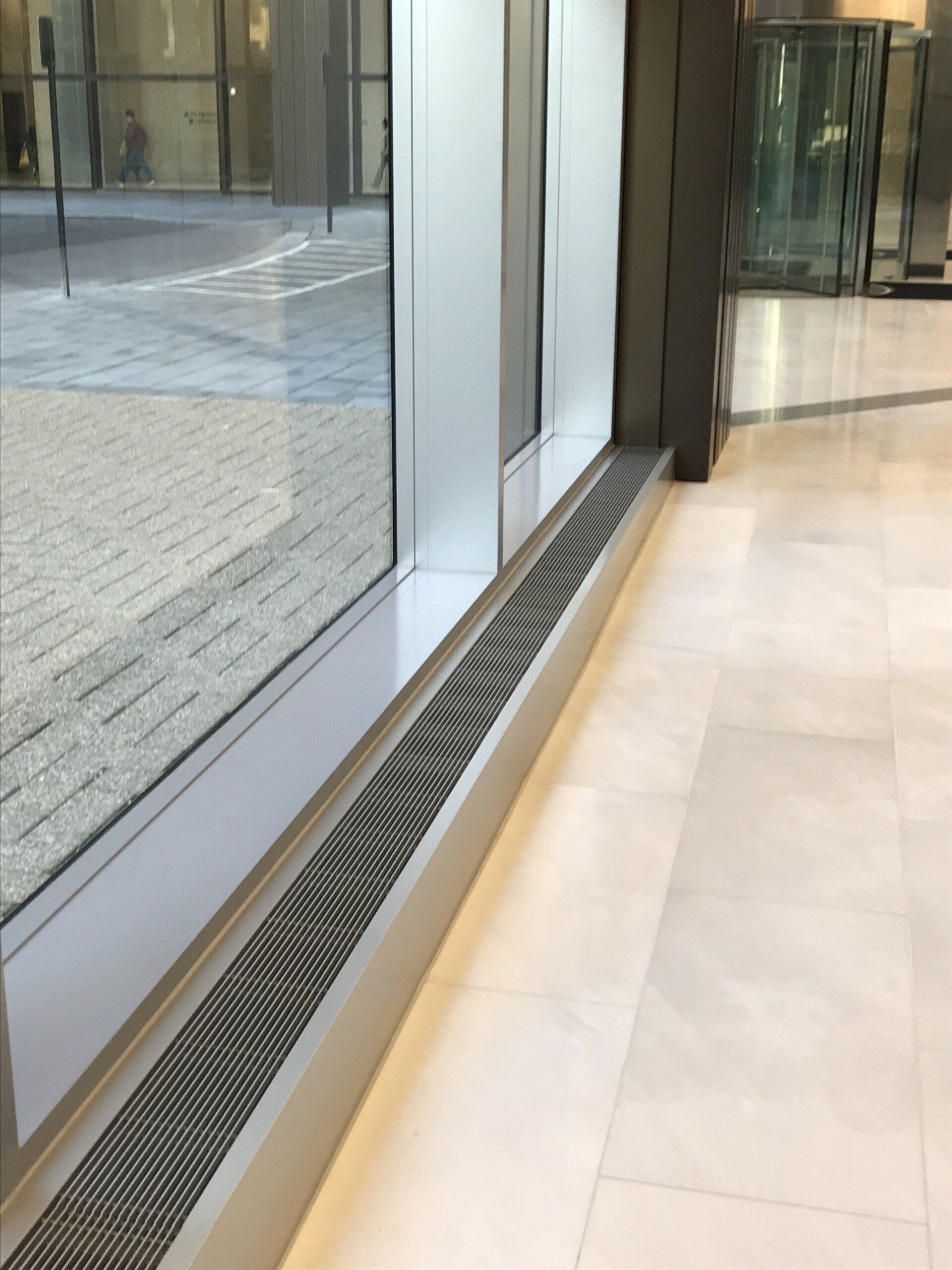 A large window with a drain underneath it