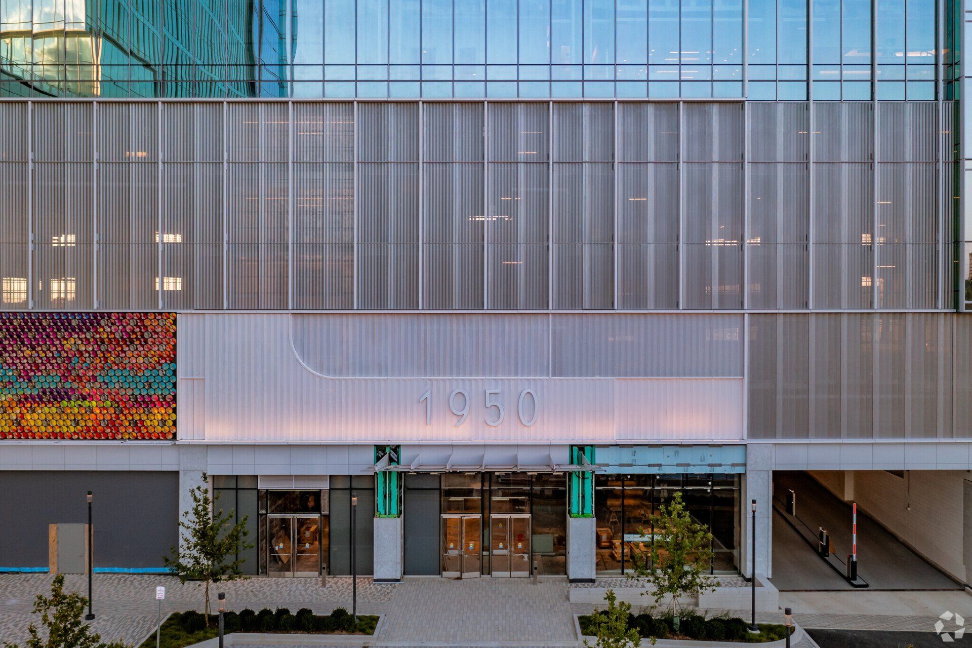 An aerial view of the entrance to a large building with a lot of windows.