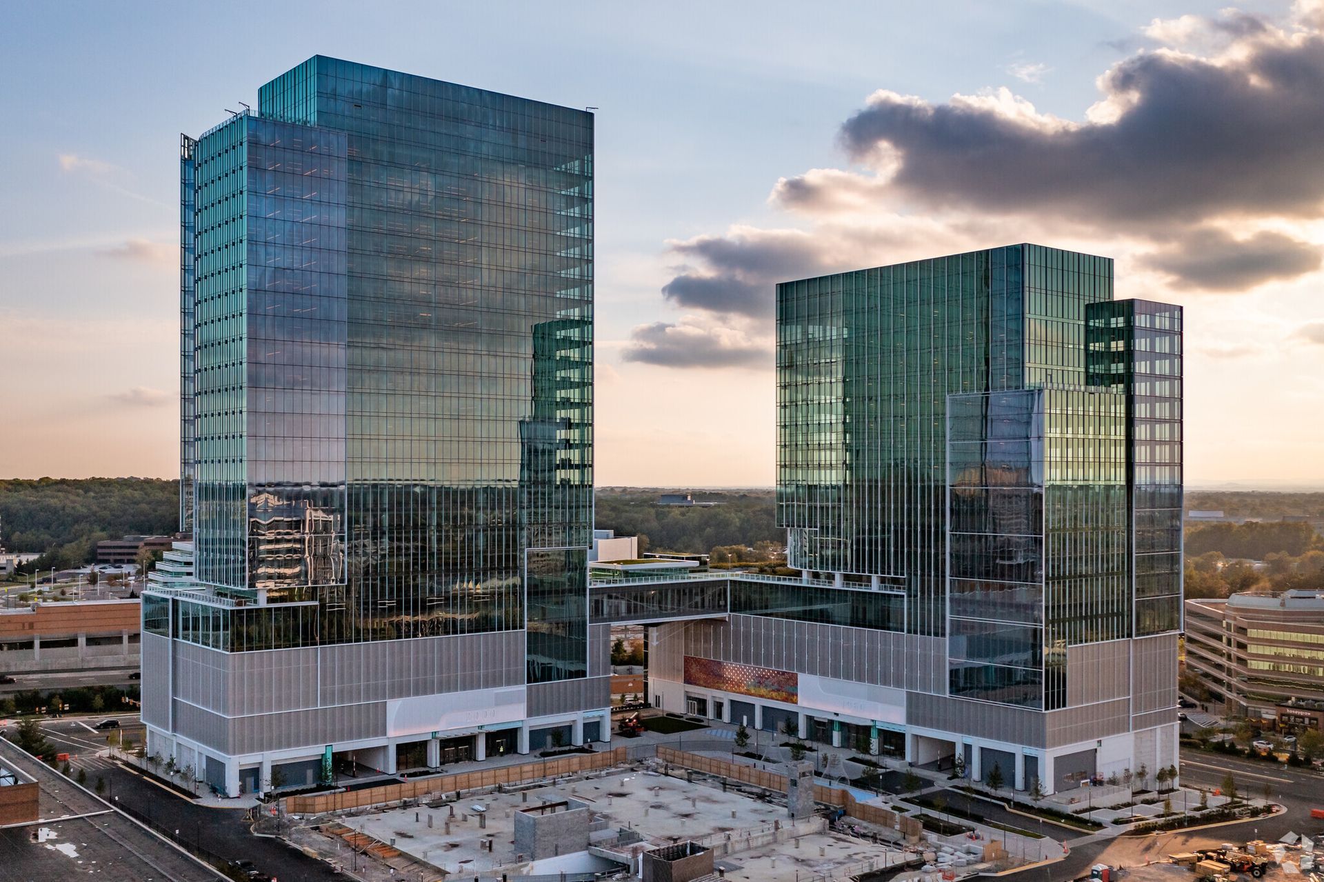 An aerial view of two tall buildings in a city.