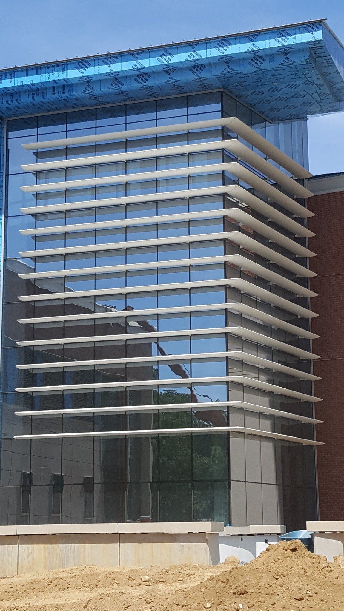 A large building with a lot of windows is being built.