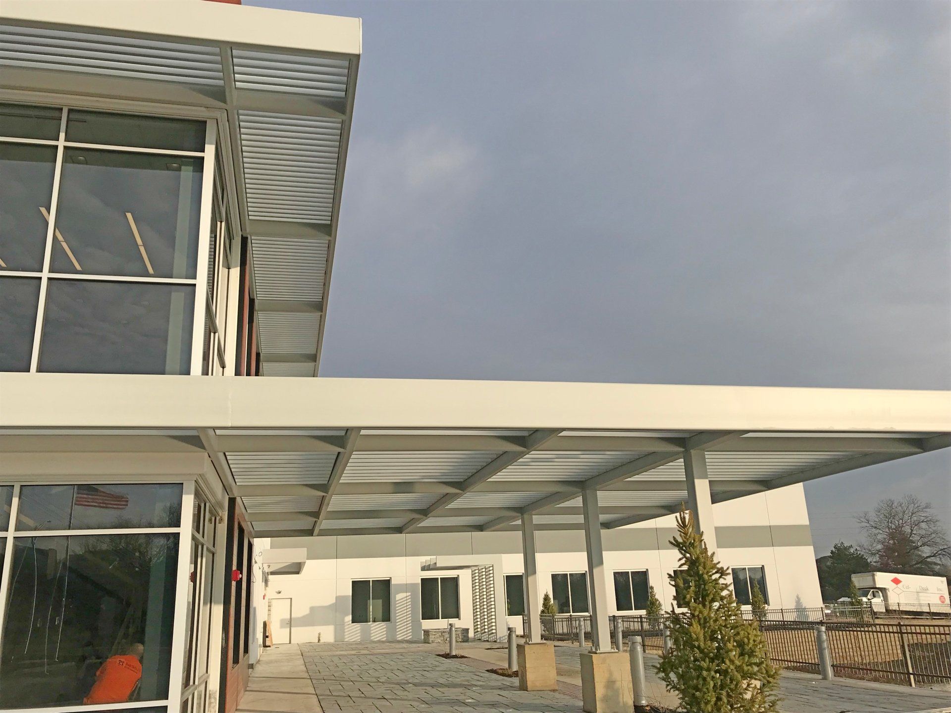 A white building with a covered walkway leading to it