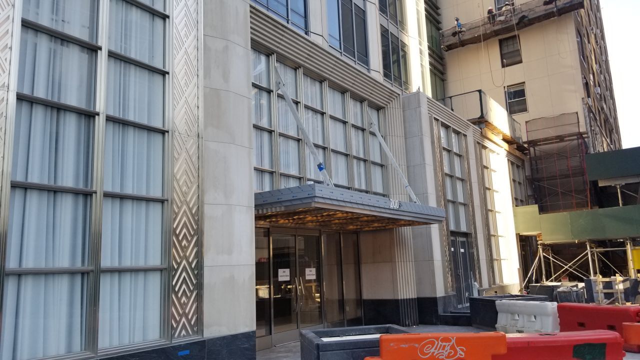 A large building with a lot of windows and a canopy over the entrance