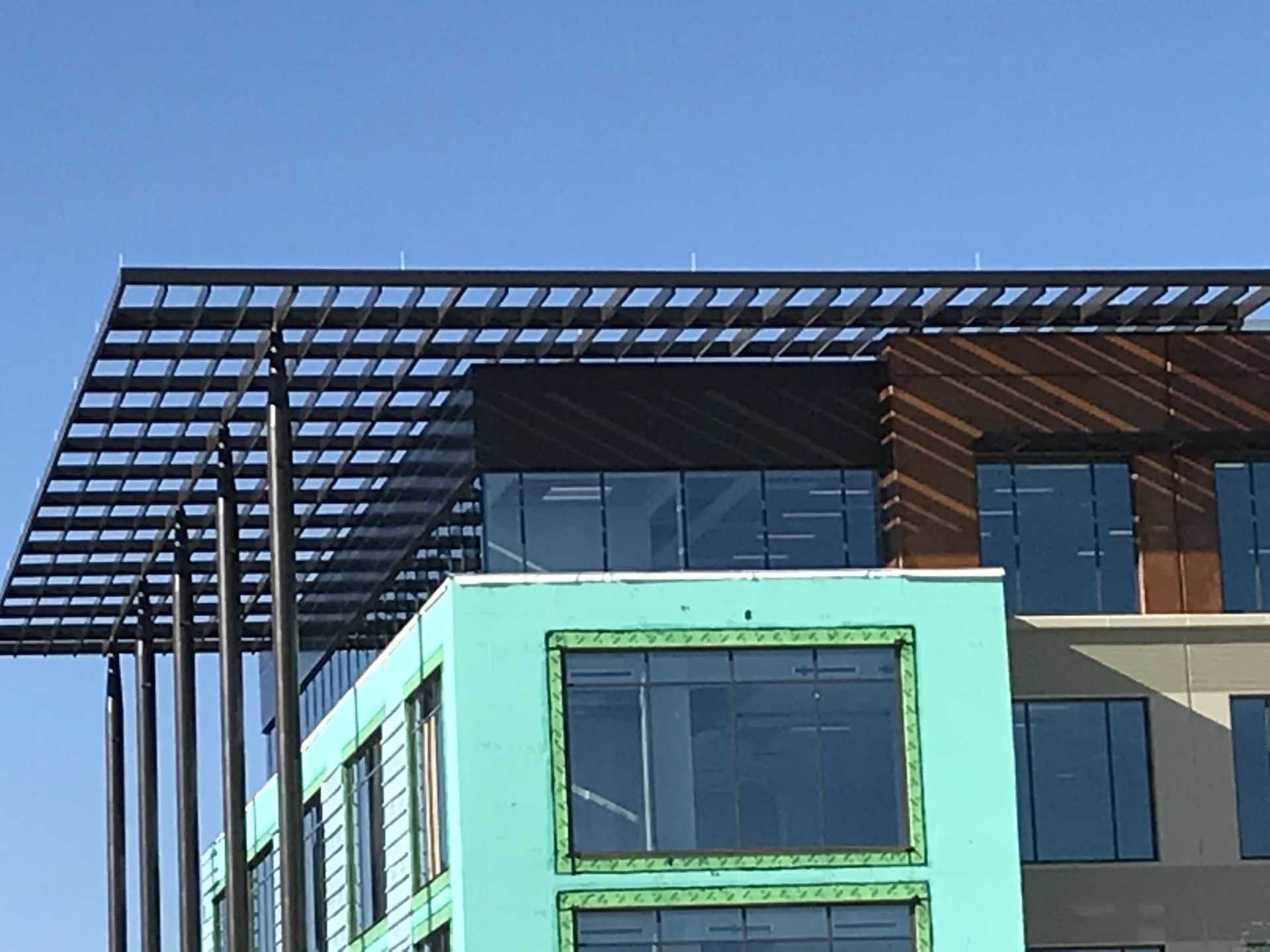 A building with a lot of windows is under construction