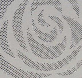 A close up of a white ceiling with a spiral pattern on it.