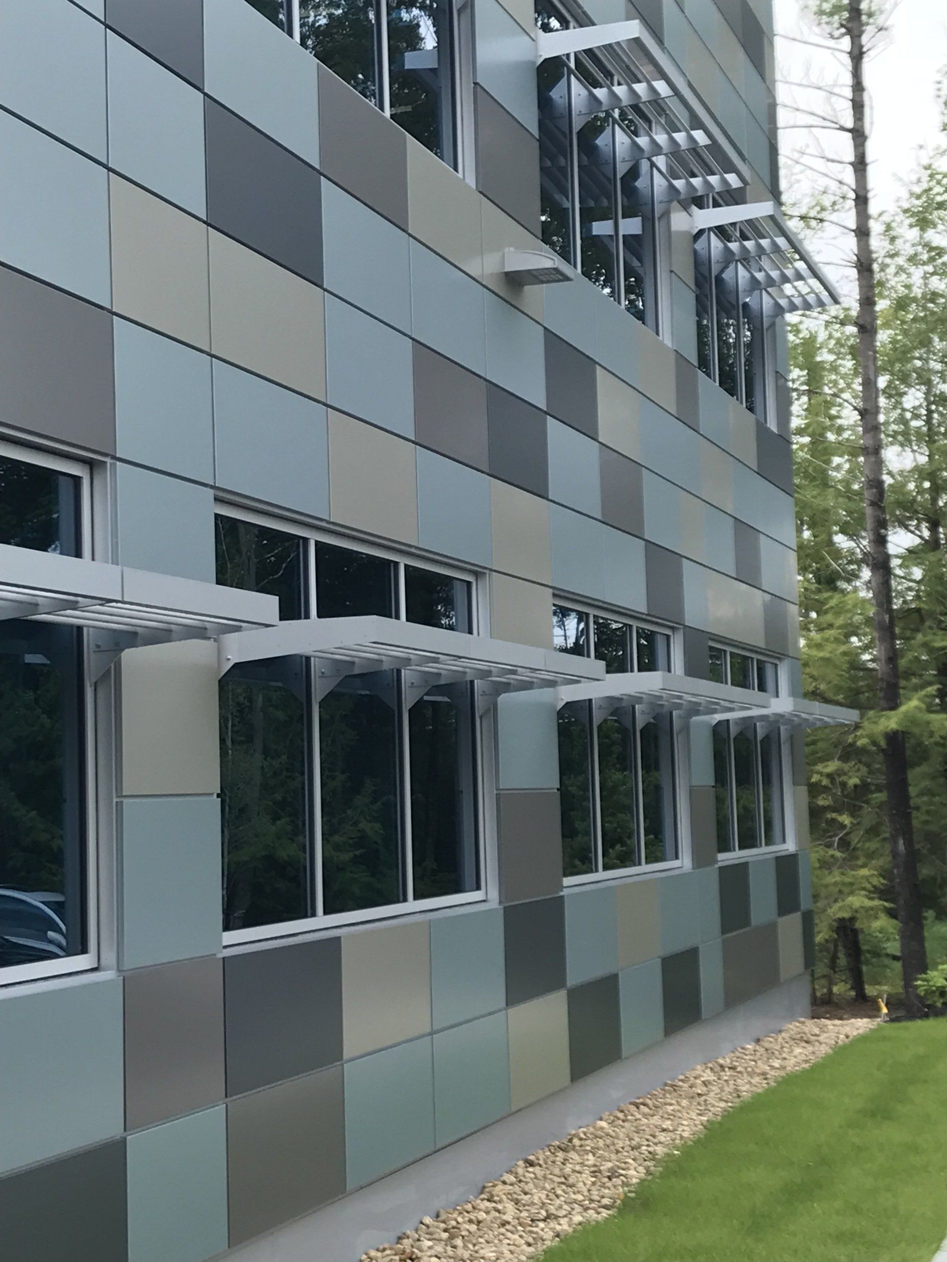 A building with a lot of windows and shades on the side