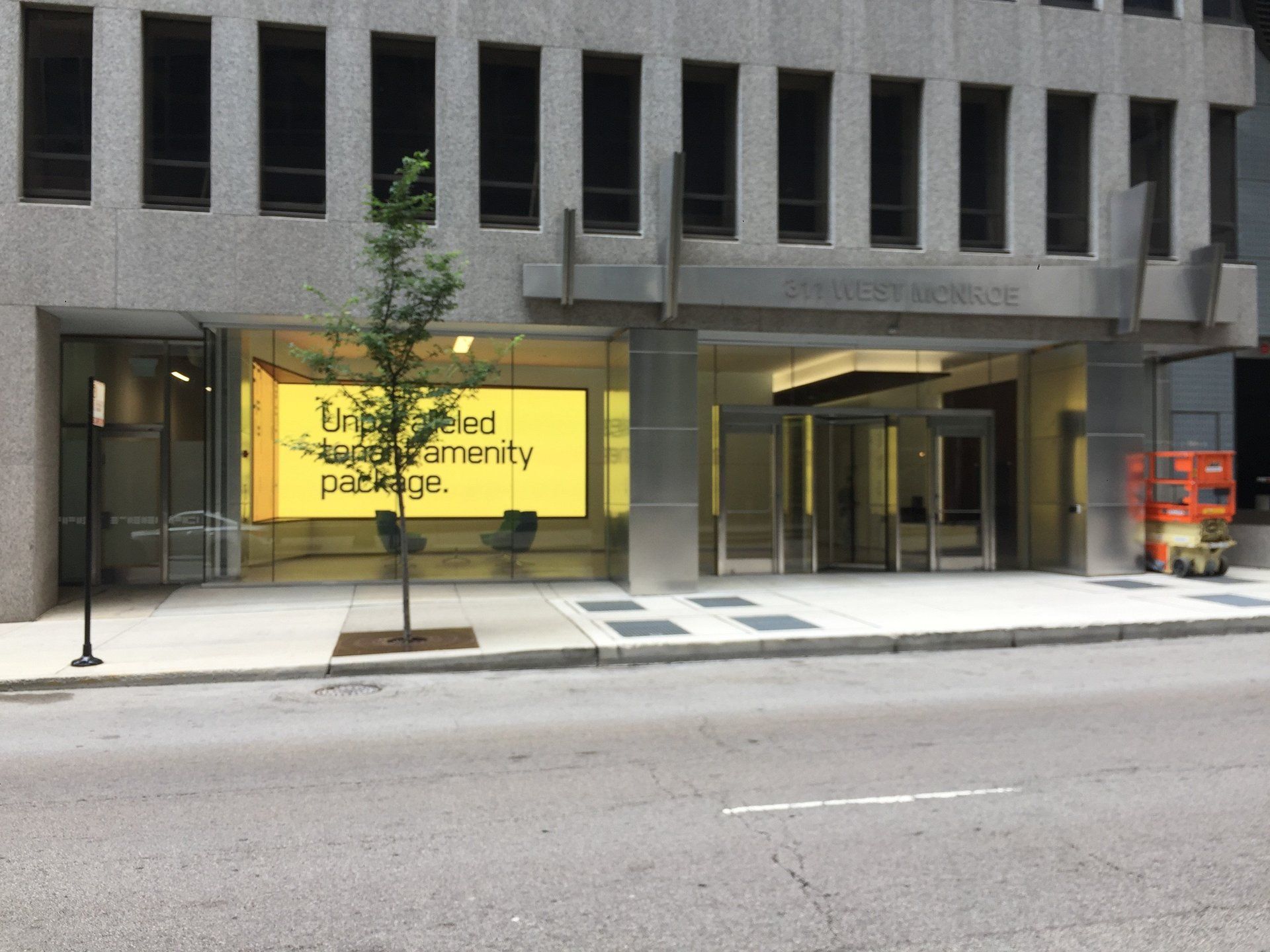 A large building with a yellow sign that says enhanced community participation