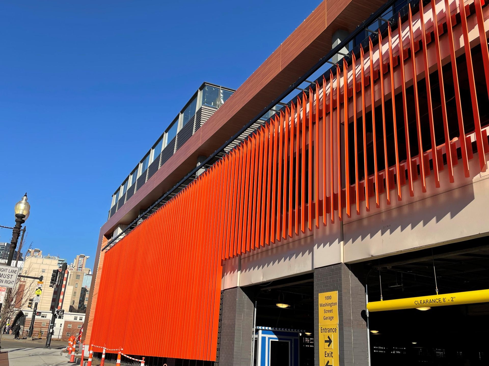 A large orange building with a yellow sign on the side of it.